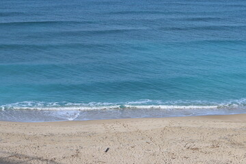 Fototapeta na wymiar Tranquil scenery. Blue sea water, sand, no people. Beautiful day on a beach.