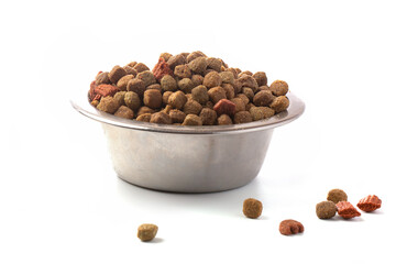 Dry cat food in an iron bowl on a white background