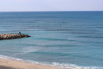 Empty beach photo. Beautiful coastline with calm seawater, sand.
