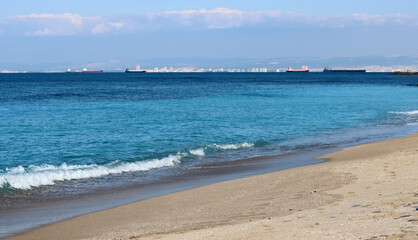 Fototapeta na wymiar Golden sand, blue sea, calm water. Beautiful seascape. 