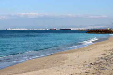 Golden sand, blue sea, calm water. Beautiful seascape. 