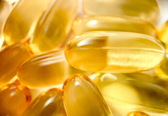 Close-up texture of many omega 3 capsules. Polyunsaturated fatty acids. The concept of a healthy...