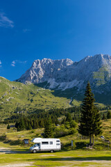 Caravan in summer mountain landscape, Alps, Italy