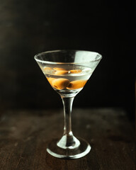 Martini with olives in an original cocktail glass.