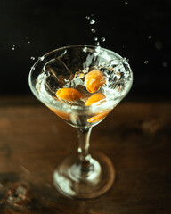 Splash martini with olives in an original cocktail glass.