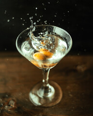 Splash martini with olives in an original cocktail glass.
