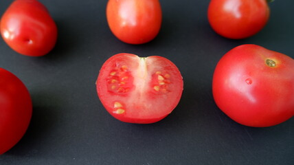 tomatoes on a black background
