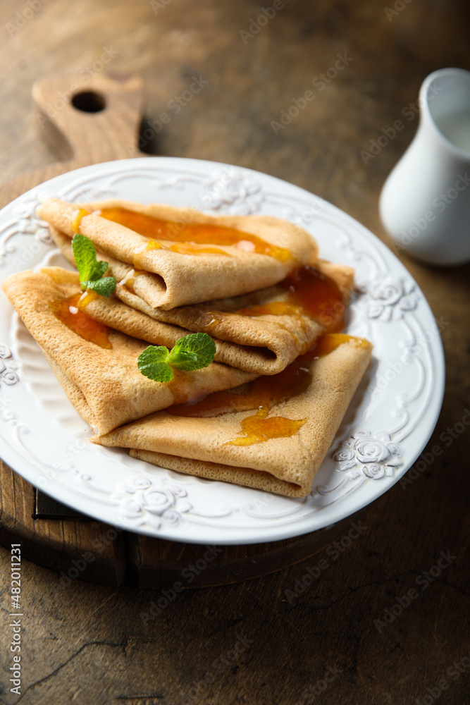 Wall mural Homemade crepes with apricot jam