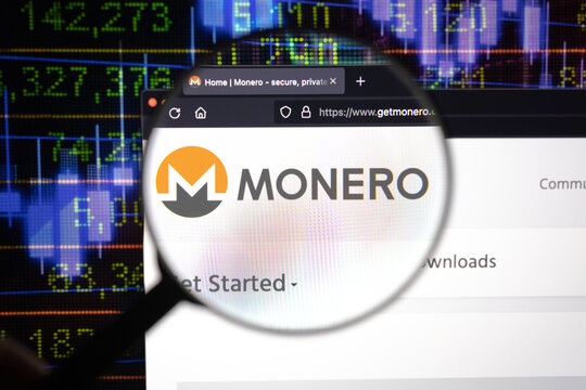 Monero crypto company logo on a website, seen on a computer screen through a magnifying glass.	