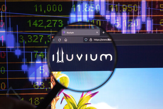 Illuvium crypto company logo on a website, seen on a computer screen through a magnifying glass.	
