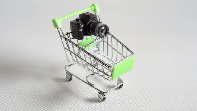 Toy metal super market trolley miniature shopping cart with toy photo camera.