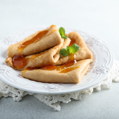 Homemade crepes with apricot jam