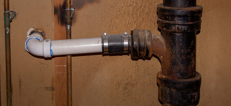 Old residential cast iron plumbing pipes showing rust