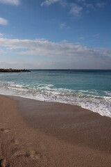 Fototapeta na wymiar Empty beach photo. Beautiful coastline with calm seawater, sand, no people. 