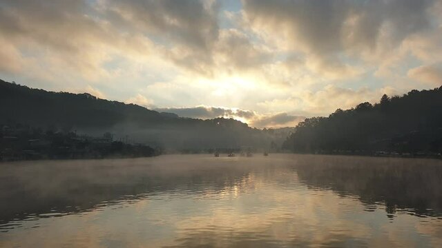 Mae Hong Son, Thaialnd. Ruk Thai village morning lake sunrise and slow moving fog with boats crusing in Nature