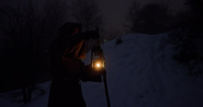 Sage man walking in winter night