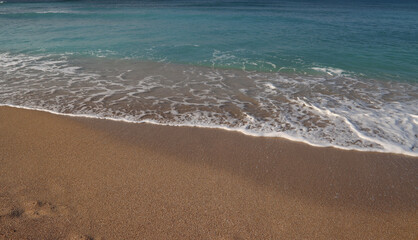Fototapeta na wymiar Empty beach photo. Beautiful coastline with calm seawater, sand.