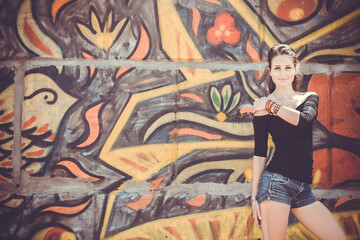 a young girl on the background of graffiti