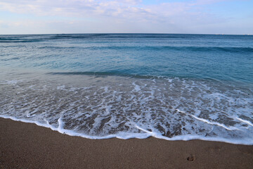 Beautiful seascape photo. Warm day in the beach. Calm blue water, clear sky, no people. 