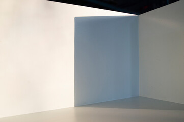 Light and shadow in the backdrop of an open white room.