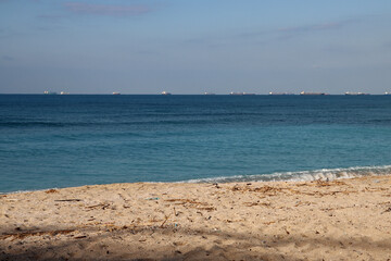 Fototapeta na wymiar Empty beach photo. Beautiful coastline with calm seawater, sand, no people. 