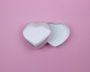 A gift box in the shape of a heart on a pink PSC in the center of the composition