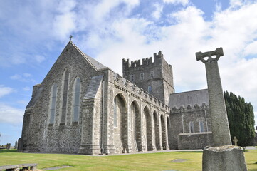 The Cathedral Church of St. Brigid in Kildare. Church of Ireland. Irish Gothic style. Ireland. Rear view with irish cross. Concept: religion, irish, traditional