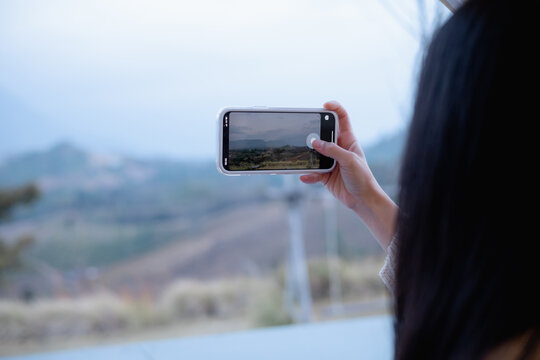 woman using smartphone take a photo at Khao Kho, Thailand