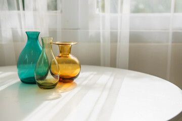 Colorful bottles on white table with sunlight