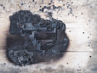 burning mark on wooden desk surface, top view of plank floor was charred