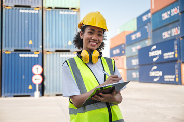 Businesswoman, foreman holding clipboard with container ship background	