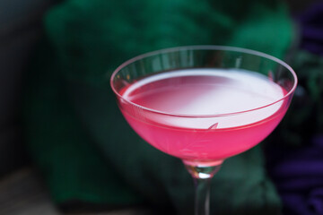 Dark key. Selective focus. Delicious pink refreshing rose drink on color background. cocktail. copy space.