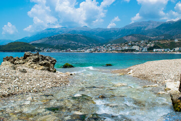 Fototapeta na wymiar Beautiful summer cloud landscape of beach town of Himare. Adriatic sea. Albania. Concept of summer holidays and relaxation.