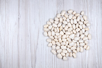 Pile white haricot bean on the table free space