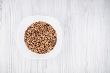 buckwheat in a white plate on the table free space. buckwheat in the kitchen