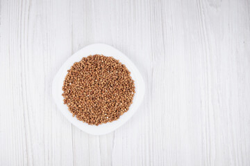 buckwheat in a white plate on the table free space