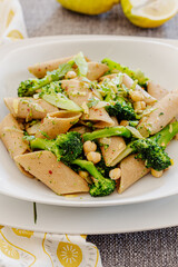 Broccoli, chickpeas, pasta and lemon. Vegan recipe. Lemons in the background