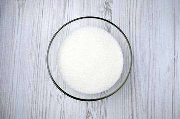 sugar in a transparent bowl. sugar on the table