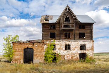 The building of an old abandoned mill in the countryside. The picture was taken in the village of Pervokrasnoe, in the Orenburg region