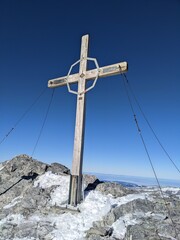 Fototapeta premium Summit cross on the Clariden summit. Ski touring in winter. The Clariden is a 3267m . Mountain of the Glarner Alps swiss