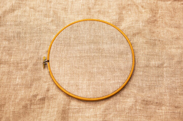 Embroidery hoop with natural linen fabric.