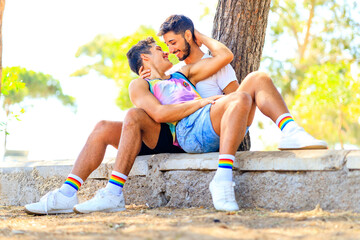 Gay couple together spending moments of happiness in green park