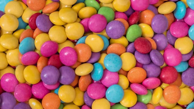 Pile of color chocolate candies on background