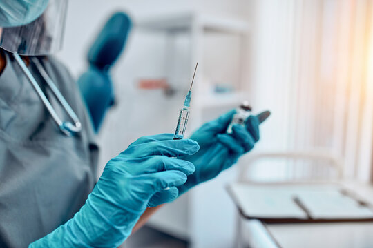Cropped image of hands holding a covid-19 vaccine and a syringe. Vaccination and preservation and protection of health.