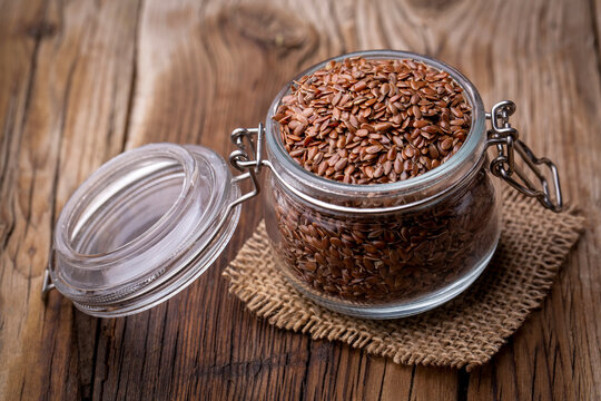 Flax seeds on a wooden background