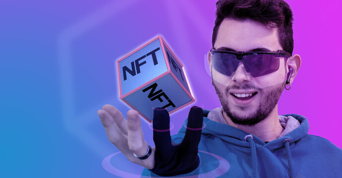 NFT word on object technology of the digital cyber universe in hand. Boy with augmented reality glasses enters virtual world to play a game. metaverse and new futuristic lifestyle.