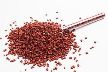 brown granules of polypropylene, polyamide. White background. Plastic and polymer industry. Microplastic products.