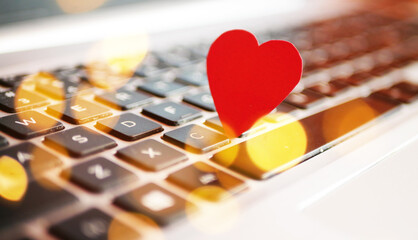 Online invitation concept. Heart on laptop. Valentines day shopping