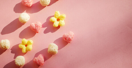 Cereals in cute shapes flat lay on pink background. Tasty sweet food. Valentines day morning breakfast 