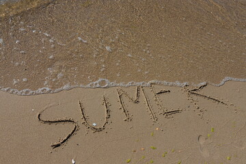 The inscription on the sand Summer symbolizes a summer vacation at the sea
